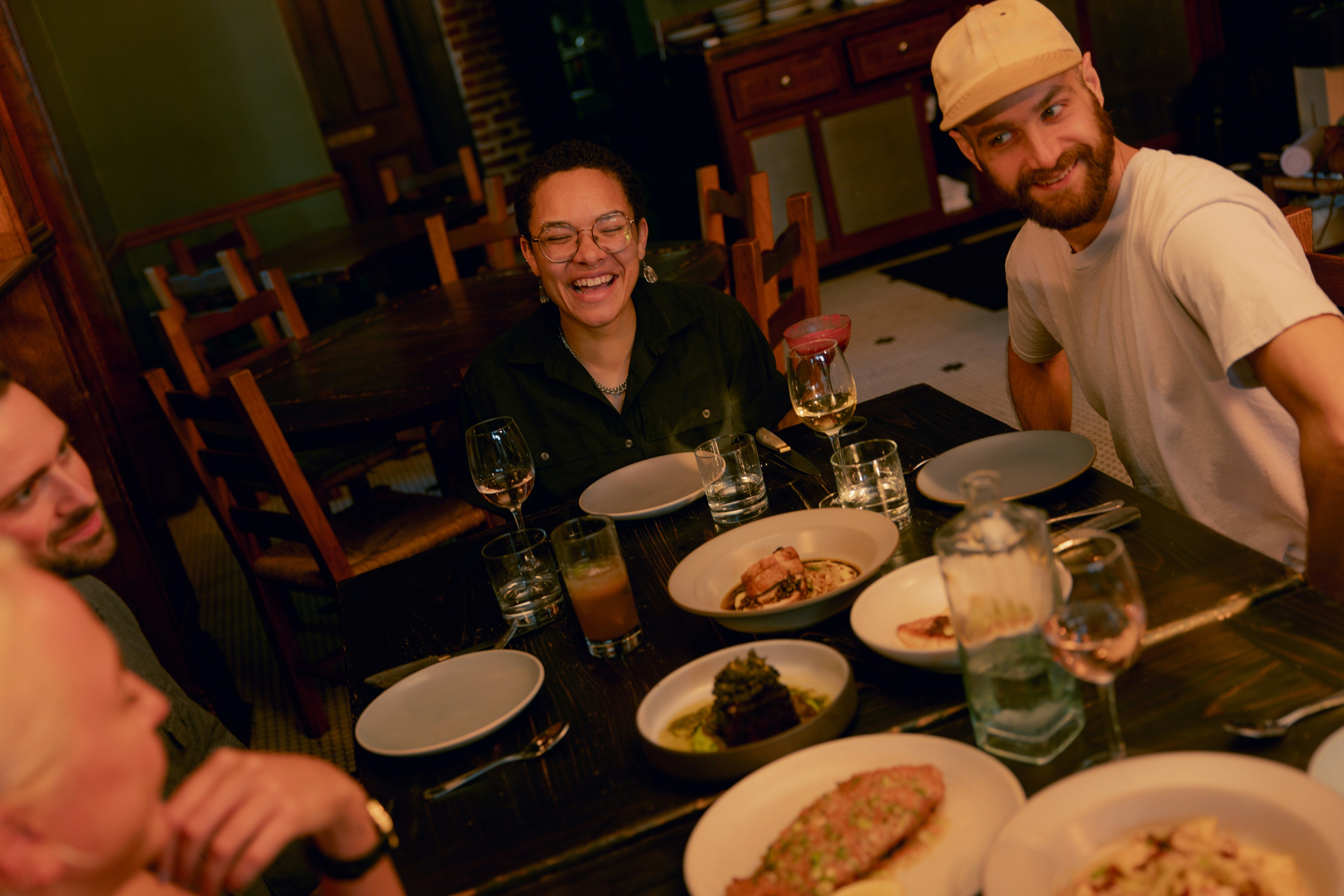 A group of people enjoying dinner together